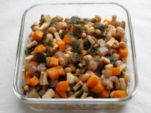 高野豆腐入り五目豆の完成品。大豆、人参、こんにゃく、昆布と高野豆腐が彩りよく煮上がり、保存容器に入っている