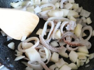 玉ねぎと一緒にイカをフライパンで炒めているところ