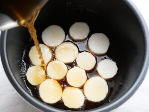 輪切りにした長芋に煮汁を注ぐ調理準備の様子