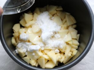 りんごと砂糖にレモン汁をまわしかけている様子