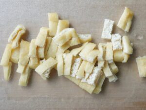 短冊切りにした油揚げをまな板の上に並べた様子