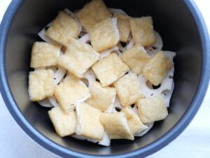 れんこんの上に油揚げを並べ入れた様子